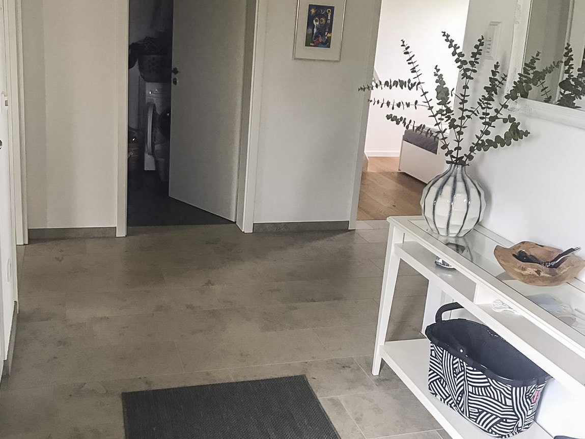 Hallway of an apartment with stone flooring.