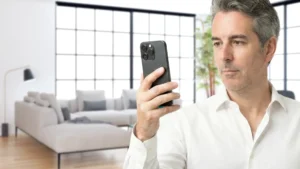 a 45 years old caucasian man is scanning a room with his iphone 16 Pro.